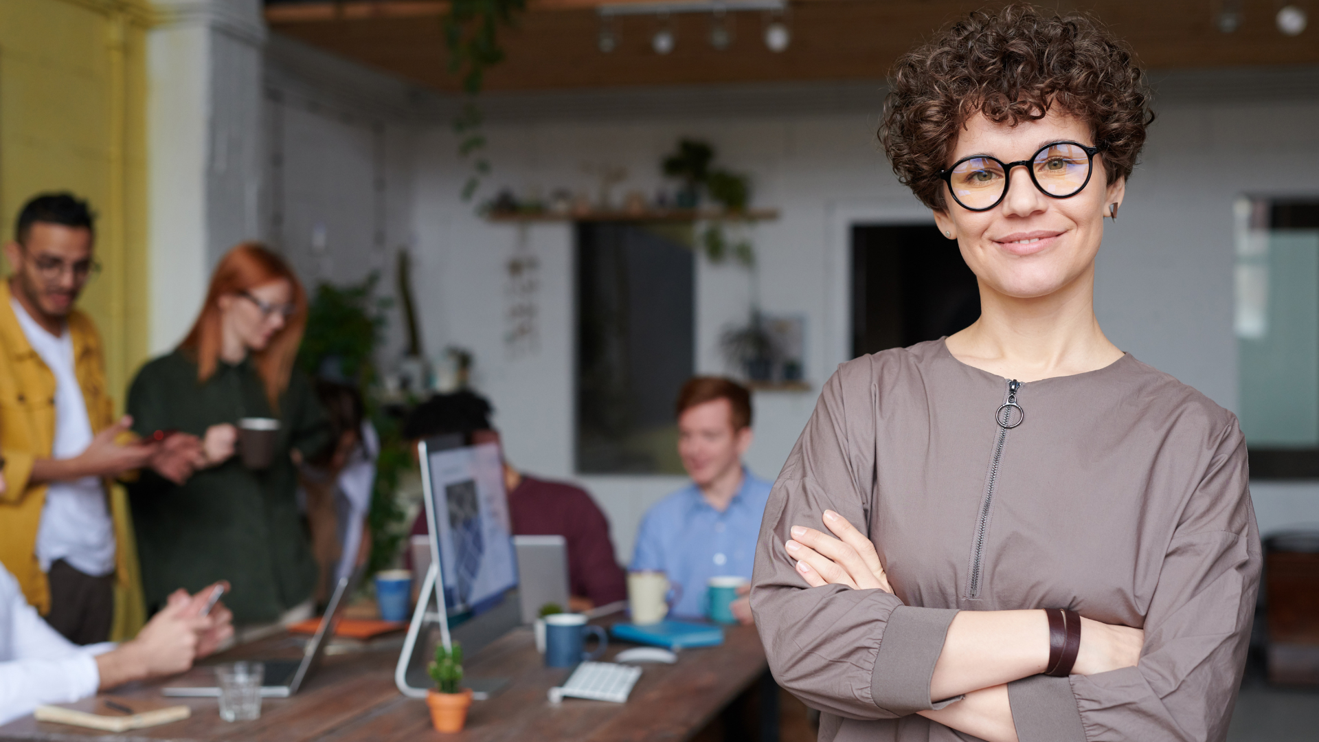 portrait of a board member with people talking in the background