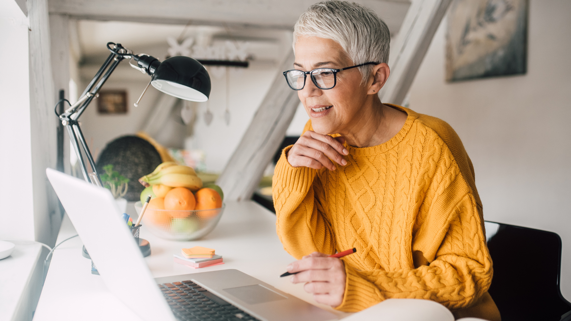 mature lady working at laptop at home