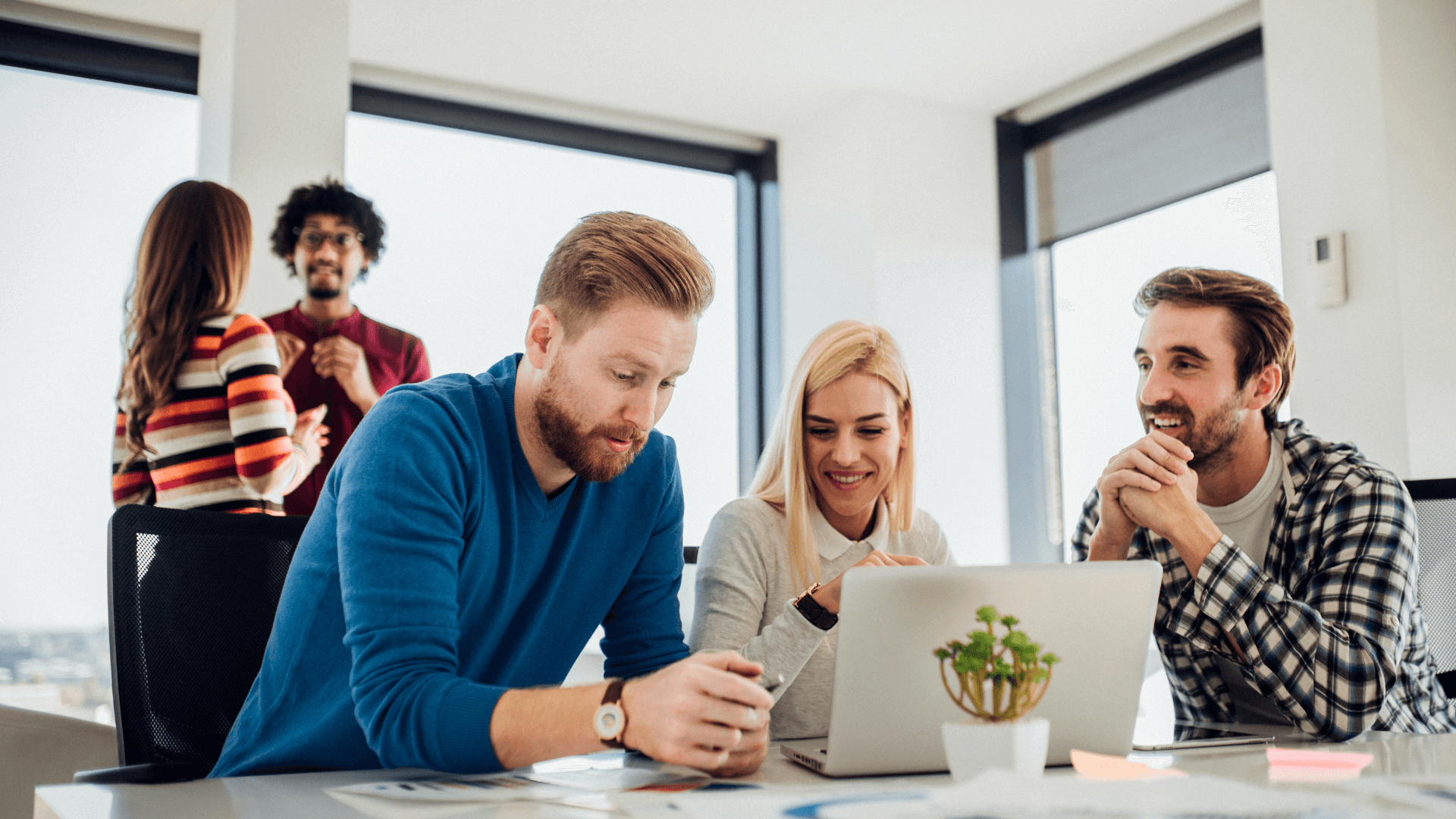 board members discussing governance and AI around a laptop